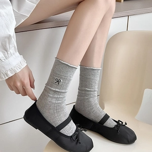 Gray crew socks with black bow embroidery and Mary Jane shoes in a sweet style