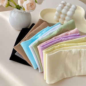 Detail of candy-colored velvet socks showing diverse pastel shades and elastic knit texture