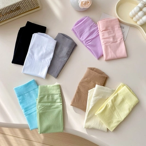 Flat lay of colorful velvet cotton socks in ten candy colors on a cream tabletop