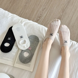 Detail of mesh hollow stripes and embroidered bow on breathable low-cut liner socks