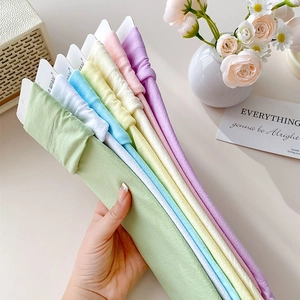 Close-up of seven candy-colored velvet socks neatly wrapped on white cards