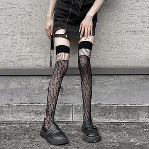 Detail of black over-the-knee socks featuring hollow diamond mesh and gothic striped patterns
