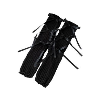 Black ribbed knit leg warmers with satin bows and lettuce edge for a balletcore look