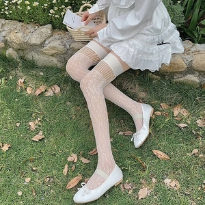 Detail of white lace over-the-knee socks with hollow mesh patterns and elastic cuffs