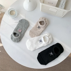 Detail view of 4 pairs of low cut socks with bow embroidery and ribbed knit texture
