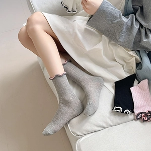 Detailed view of women's mesh socks with ruffled trim and contrast wavy edge design