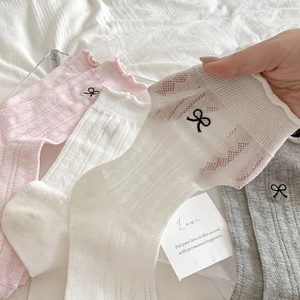 Detail of ballet style bow embroidery on breathable mesh socks with ruffled cuffs
