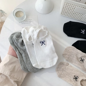 Detail of mesh breathable women's low cut socks with delicate bow embroidery decoration