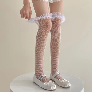 Detailed view of white fishnet stockings with ruffle lace trim in Lolita style
