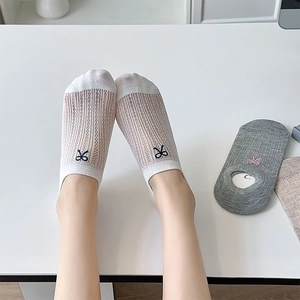 Detailed view of breathable mesh low-cut socks with elegant bow embroidery design