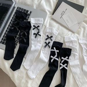 Detail of Lolita style hollow bow calf socks in various black and white color combinations