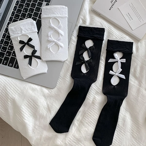 Detail of Lolita style hollow-out calf socks with ribbon bows in black and white colors