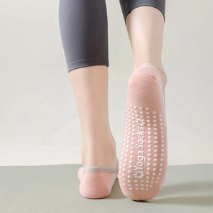 Pink yoga socks with white non-slip silicone grips and comfortable low cut ankle design