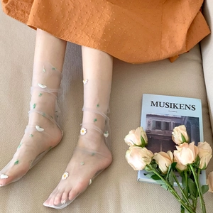 Close-up of white mesh tulle socks featuring exquisite daisy embroidery details