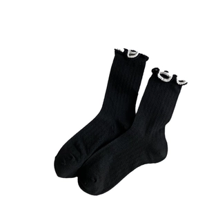 Japanese style black cotton socks with white ruffle trim and vertical ribbed texture