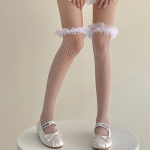 Detail of white fishnet over-knee socks featuring elegant layered lace ruffles and mesh texture