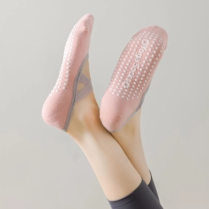 Close-up of pink yoga socks with non-slip silicone grips and grey elastic straps