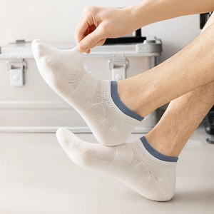 Close-up of white mesh ankle socks showing stretchable fabric and breathable texture