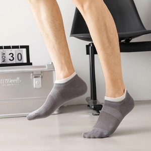 Detail showing breathable mesh texture and white ribbed cuff on gray men's low cut socks