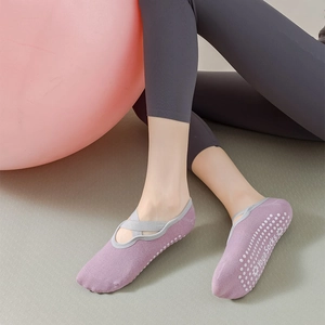 Close-up of lavender yoga socks with grey elastic straps and non-slip silicone grip bottom