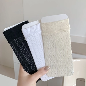 Detailed view of three pairs of hollow mesh lace socks in black, white and cream colors