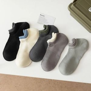 Flat lay of five pairs of men's breathable mesh ankle socks in neutral colors on white
