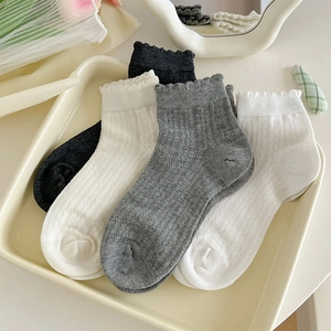 Detailed macro view of lace trim and hollow mesh pattern on breathable cotton ankle socks