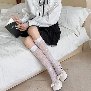 Detail of white hollow lace knee-high socks with floral mesh pattern for a JK school style