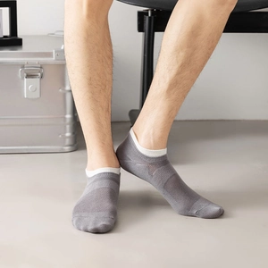 Close-up of gray breathable mesh low-cut socks for men showing elastic knit texture