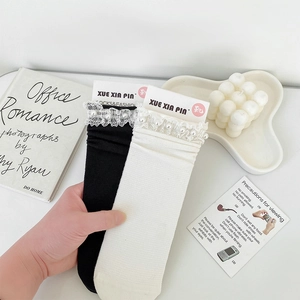 Detail of delicate lace trim and imitation pearl beads on breathable JK style socks