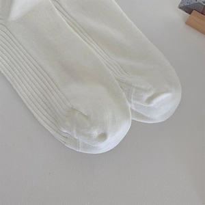 Close-up of seamless toe stitching on white ribbed knit cotton ballet style socks