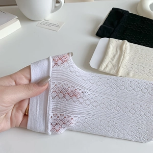 Detailed view of floral lace pattern on white breathable mesh socks for summer