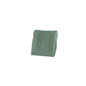 Soft moss green solid color calf socks in a minimalist folded display on white background