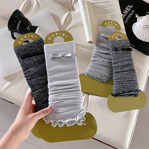 Ballet style knit leg warmers with bows and shimmering metallic yarn for women