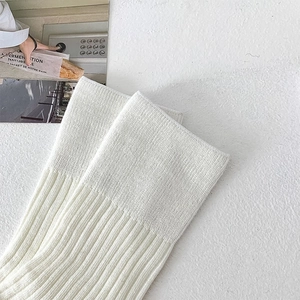Close-up of white ribbed knit fabric texture and premium segmental knitting on socks