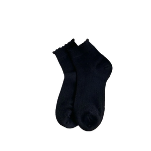 Minimalist black knitted ankle socks for women featuring elegant wavy lace trim cuffs