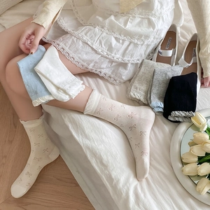Detailed view of sweet white bow-knot socks with lace frill cuffs in various colors