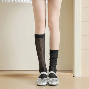 Detail of black vertical striped sheer socks showing smooth and slouchy styling options