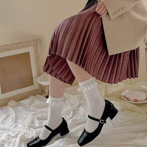 White Lolita ruffle socks with lace trim and mesh pattern paired with black Mary Janes