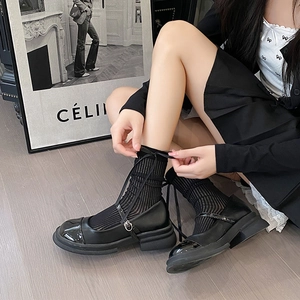 Ballet style calf socks with black ribbon bow paired with Mary Jane shoes