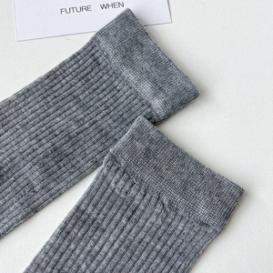 Close-up of grey ribbed cuffs on cotton calf socks showing soft knit texture and elasticity