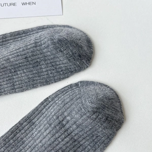 Close-up of grey ribbed knit texture on toe part of minimalist cotton calf socks