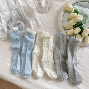 Detail of sweet bow pattern cotton socks with delicate lace trim in pastel colors