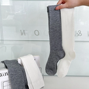 Close-up of white ribbed cotton socks featuring breathable vertical striped texture