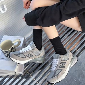 Classic grey retro sneakers with black mid-tube socks for a stylish casual daily look