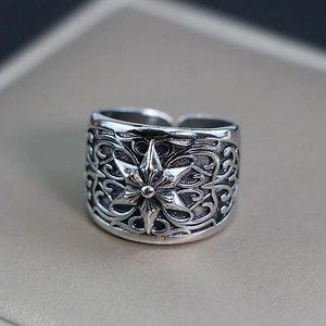 Retro punk style wide silver ring featuring a detailed star relief and open band
