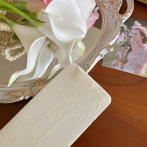 Close-up of cream lace mesh socks with vintage diamond texture and floral props