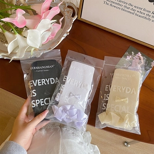 Detailed view of lace mesh calf socks with sweet bows in elegant gift packaging