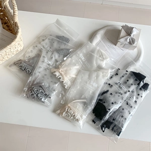 Detailed close-up of polka dot mesh socks with silk bows in individual packaging