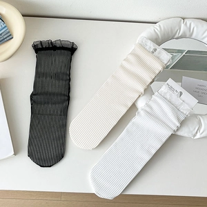 Detailed view of three pairs of mesh and ribbed crew socks with lace organza trim